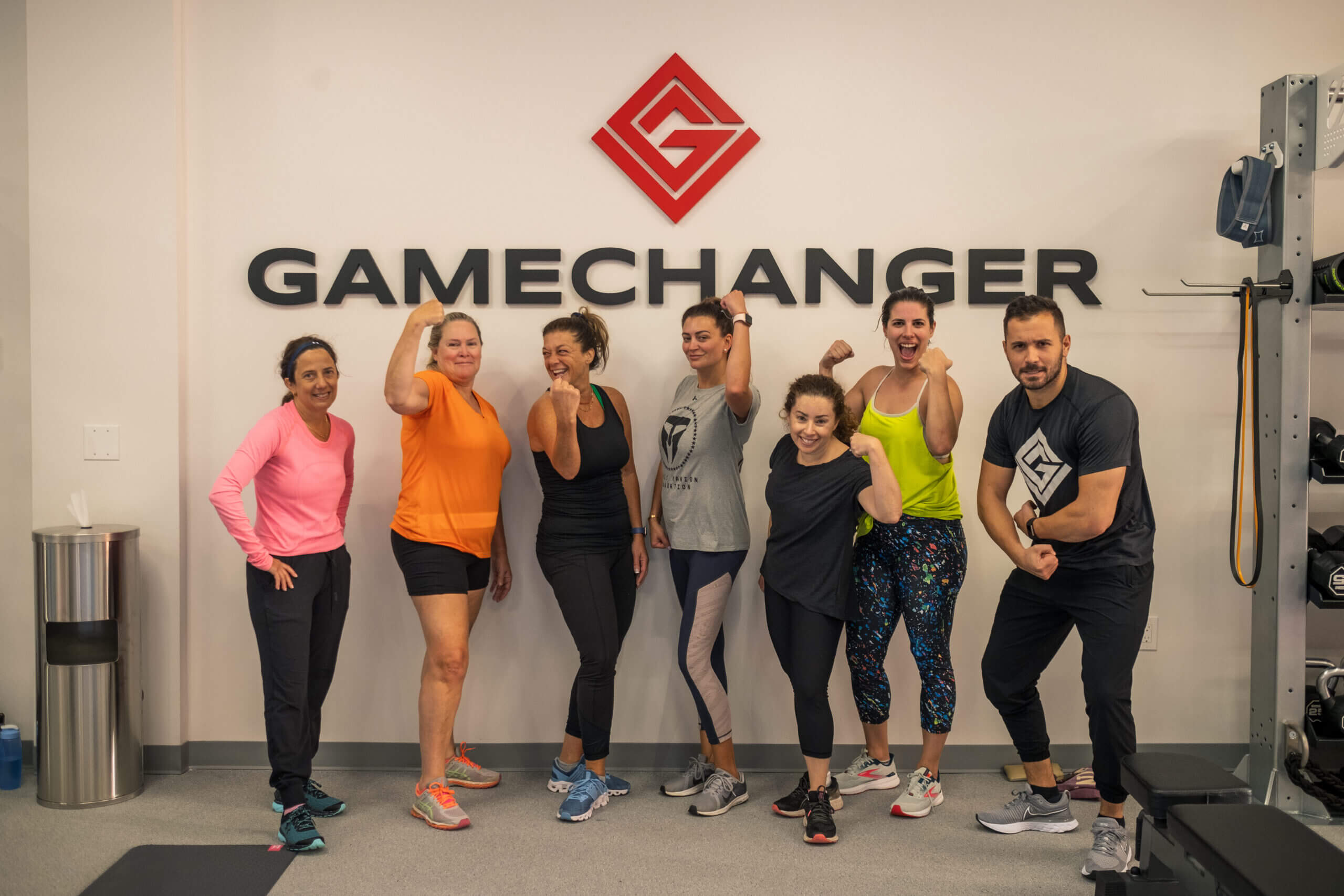 a GROUP OF PEOPLE STANDING AT THE GAME CHANGER LOGO